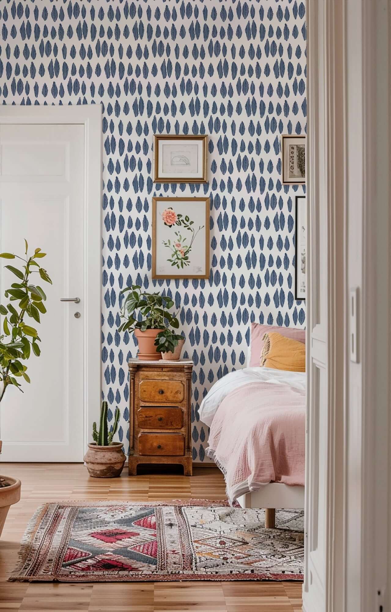 Bedroom with blue patterned wallpaper, wooden nightstand, and pink bedding.