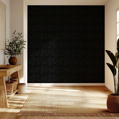 Modern interior with a textured black wall, wooden floor, and decorative plants.