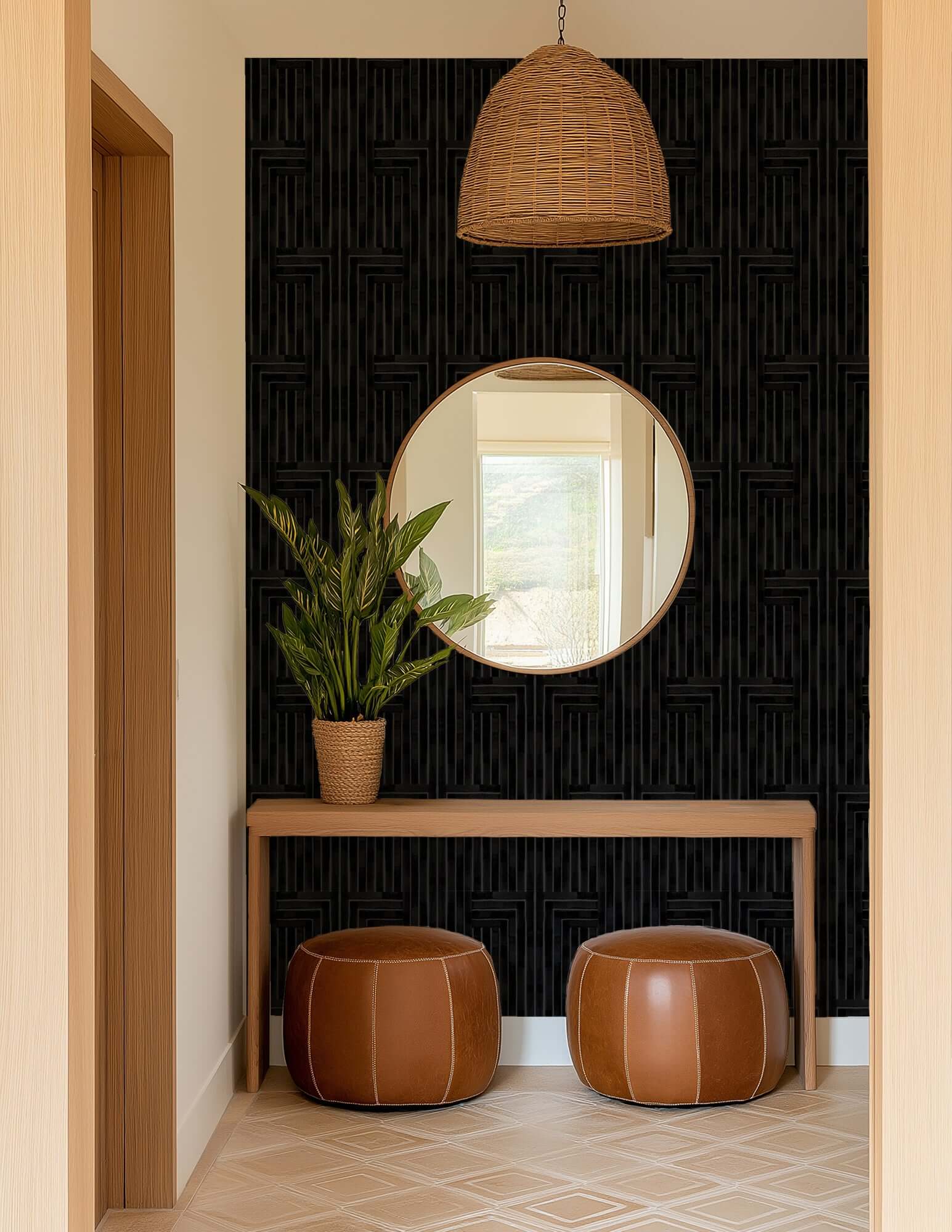 Foyer with round mirror, potted plant, and leather stools against a black textured wall.